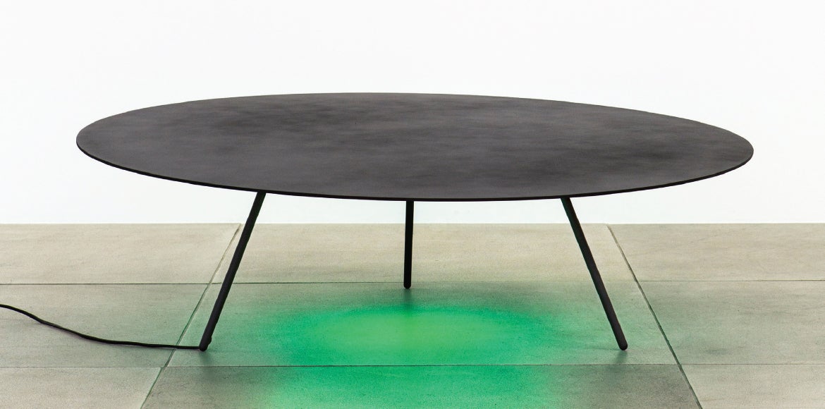 Circular table with green light underneath