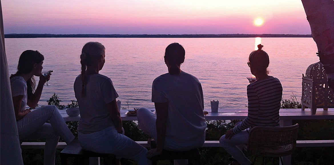 Friends drinking outside by the water