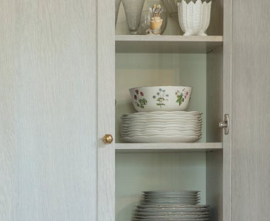 Plates and bowls in kitchen cabinet
