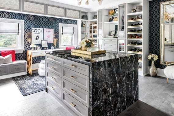 Opulent closet space in grey finish with gold hardware