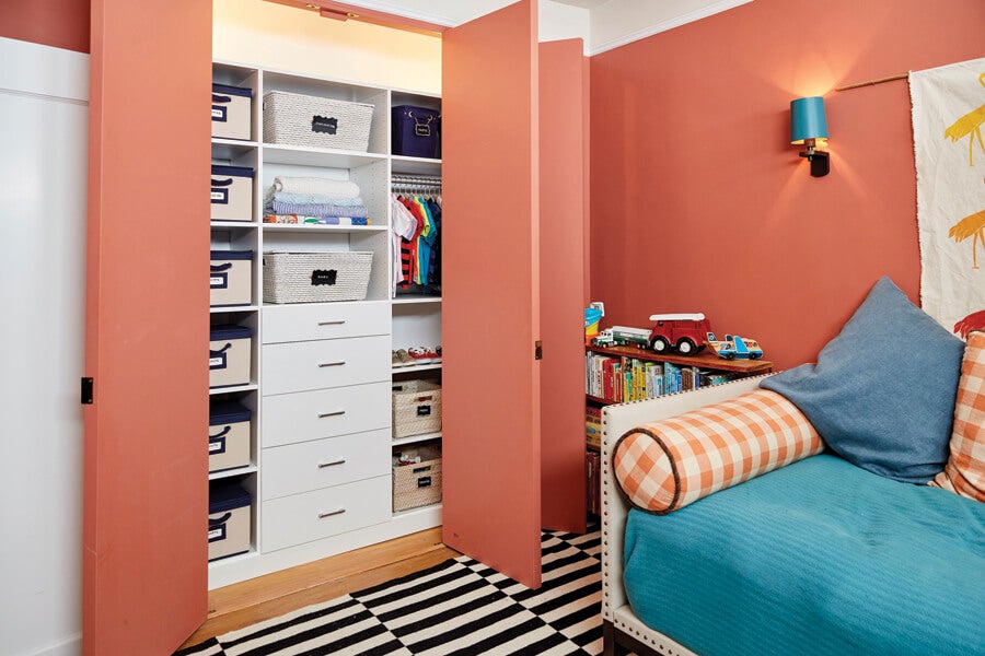 Blue day bed in peach walled playroom with reach in closet