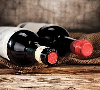 Wine Bottles on Wooden Table with Burlap Underlay
