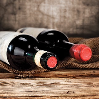 Wine Bottles on Wooden Table with Burlap Underlay