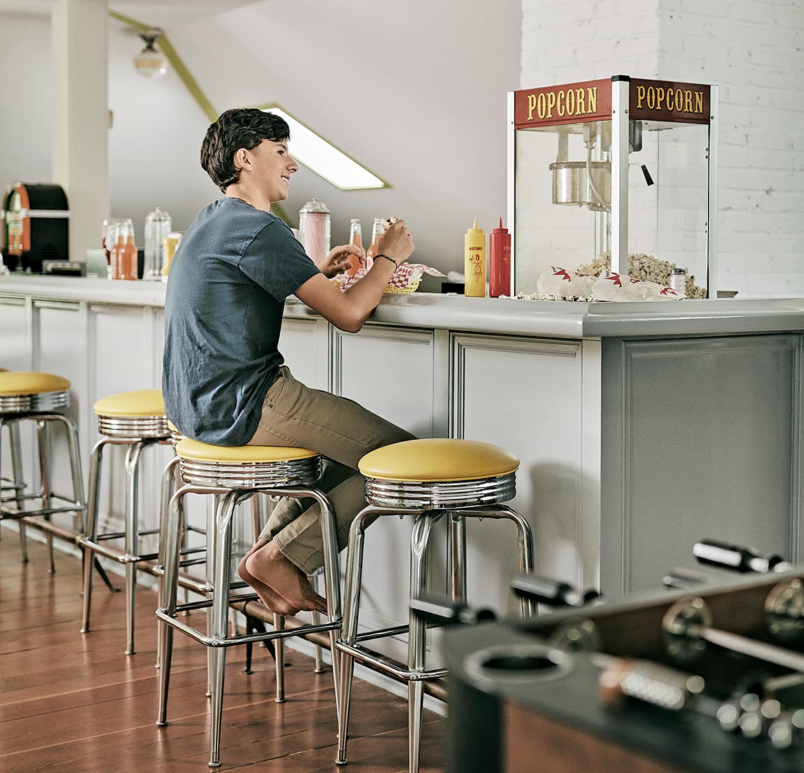 Spreading out home diner with popcorn machine and bar stools