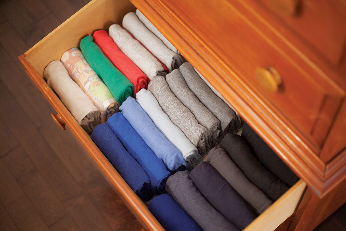 Organized clothes in wooden drawer