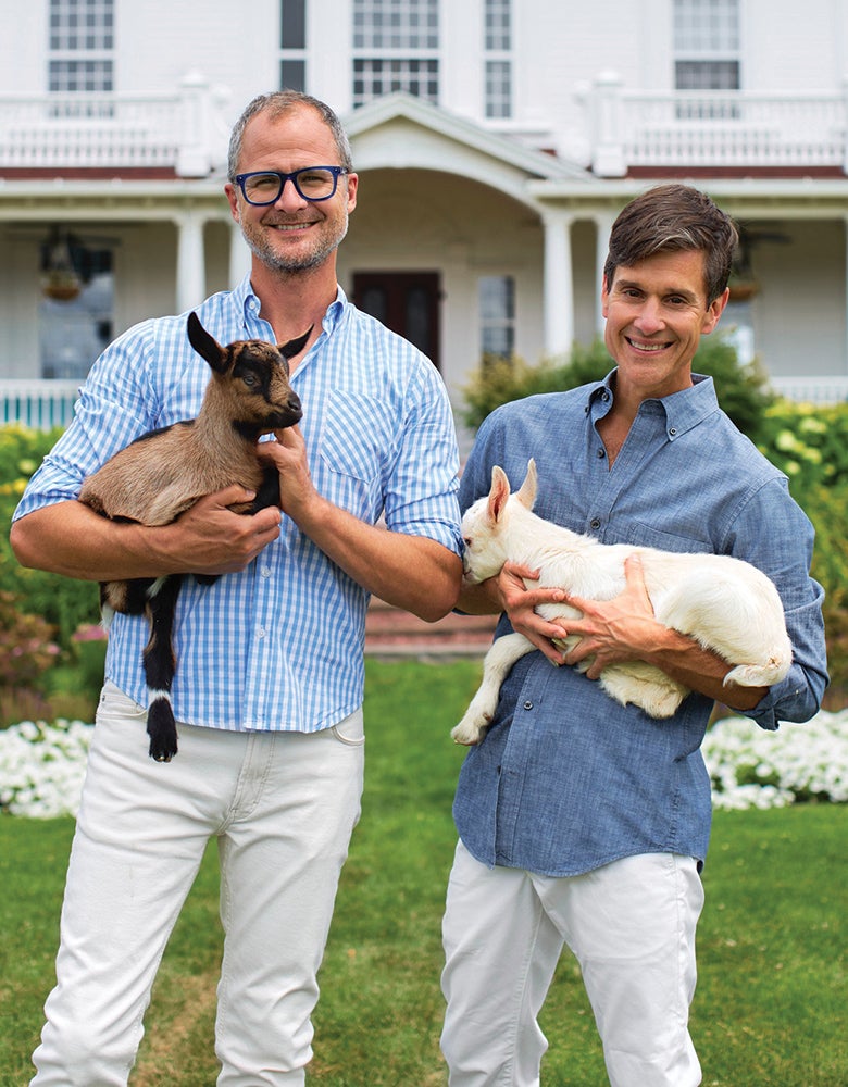 Josh and Brent holding goats