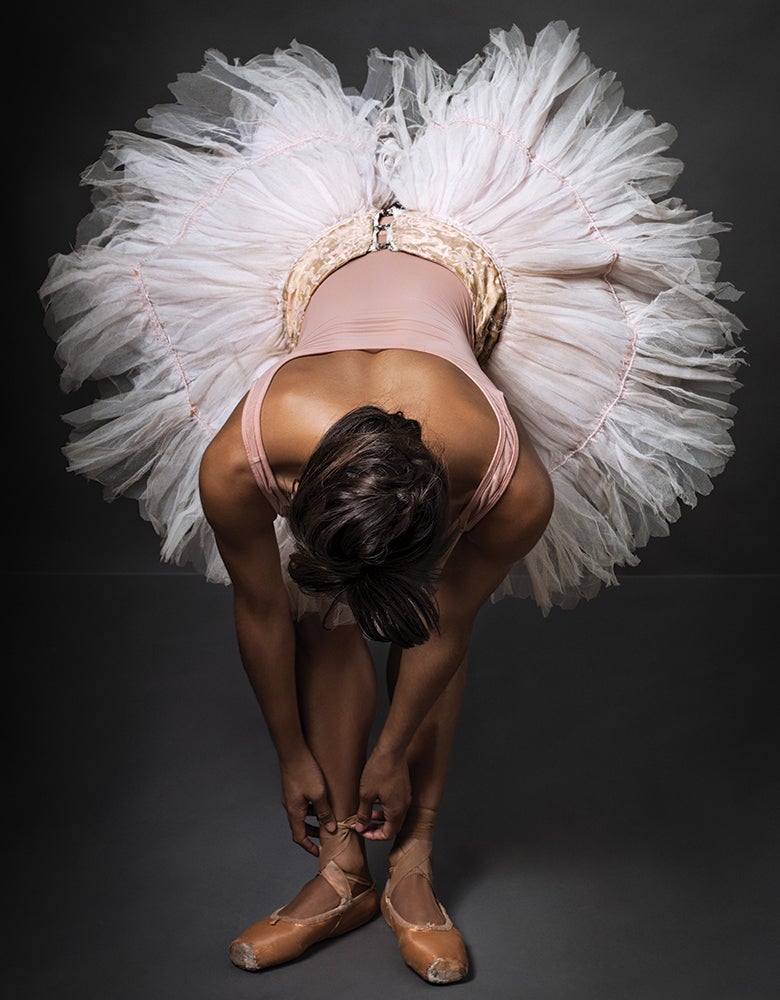 Misty in ballerina outfit tying her shoe