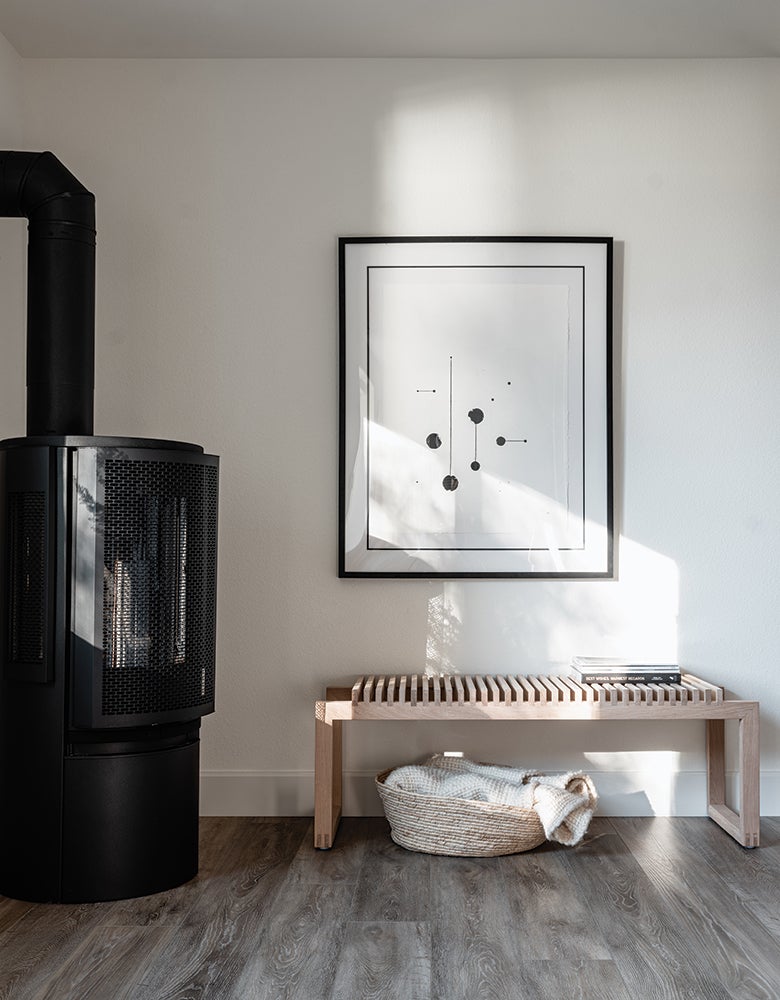 Erin Hiemstra's small space nook with a bench and freestanding gas stove.