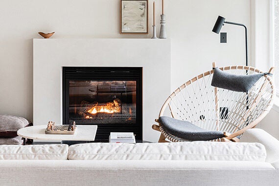 Scandanavian-inspired white family room with shelves by California closets