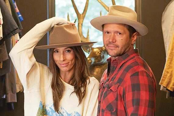 John Rankin and Meritt Elliott in his custom closet in wood finish California Closets