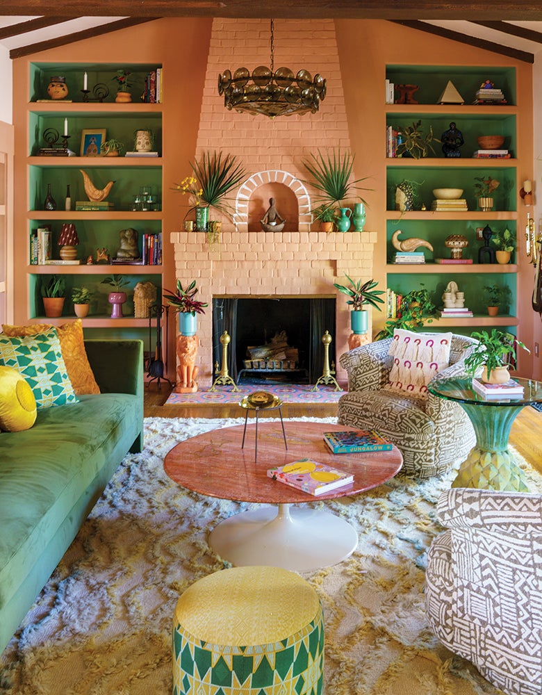 Family room shelving in terra cotta and green finishes designed by Justina Blakeney