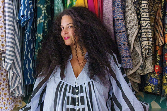 Justina Blakeney's custom closet showcasing her colorful wardrobe designed by California Closets