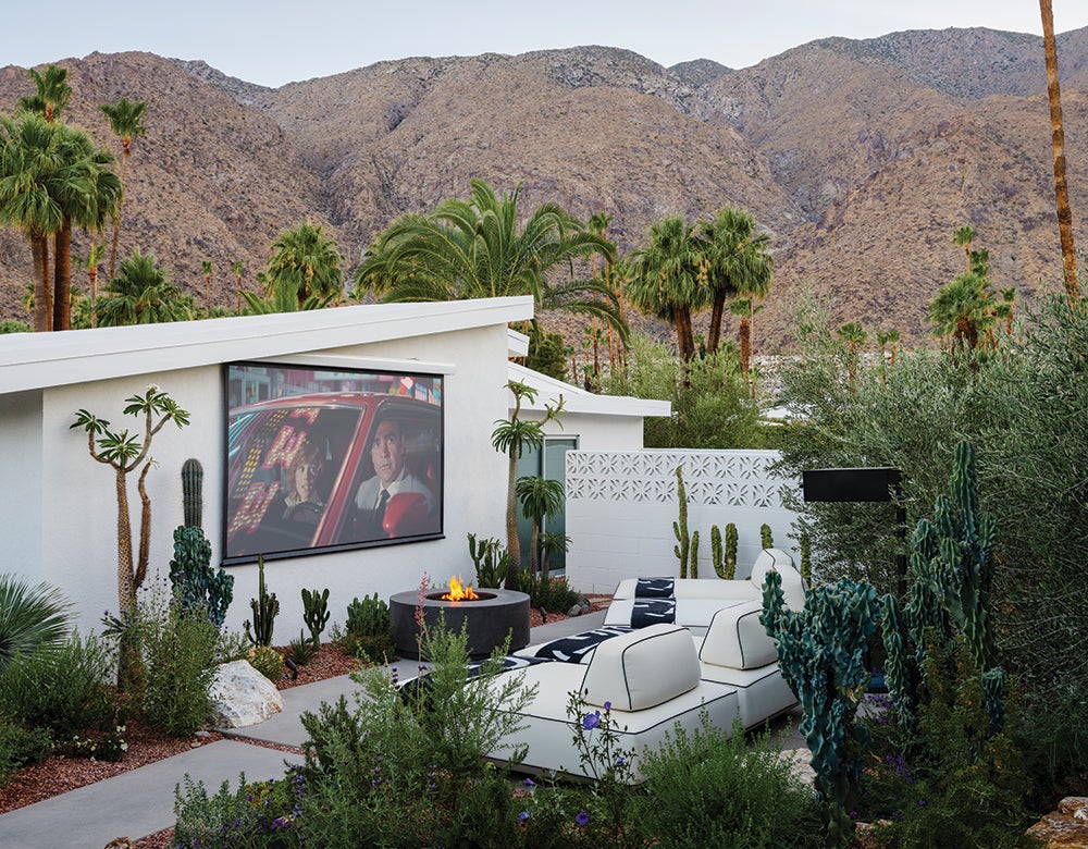 Matt sorum and Ace Harper's midcentury backyard oasis with move theater and firepit