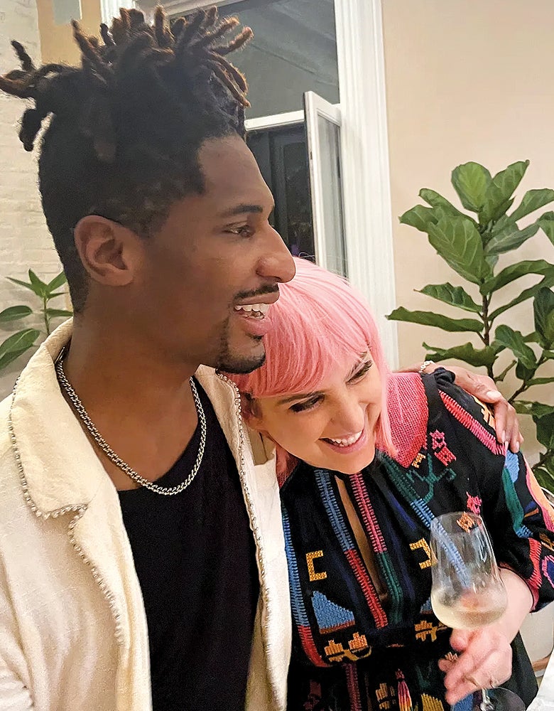 Close up of happy couple Jon Batiste and wife, Suleika Jaouad in front of their Brooklyn home with California Closets